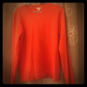 A JCREW Women’s sweater in bright red. Size M
